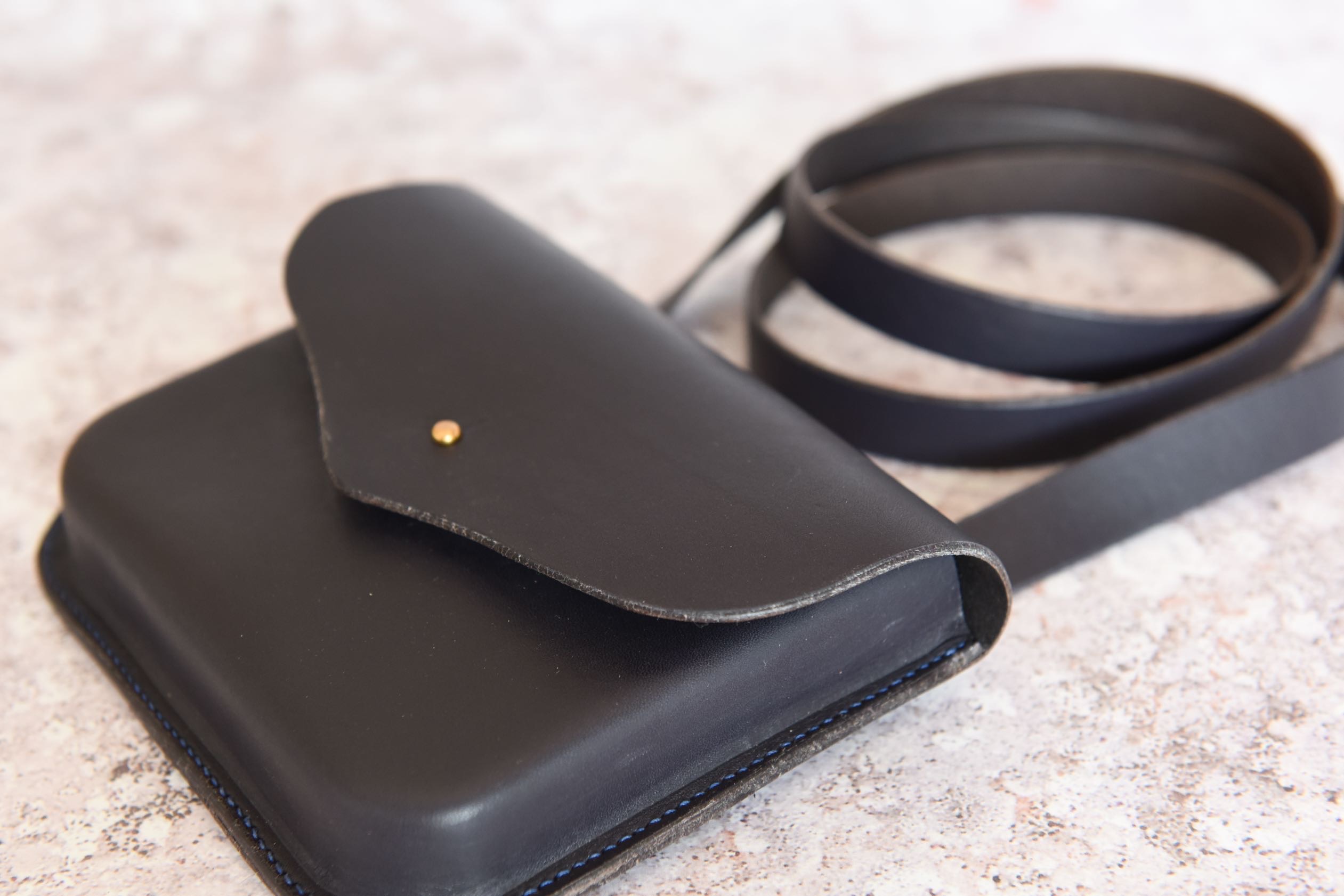 close up shot of navy moulded leather handbag